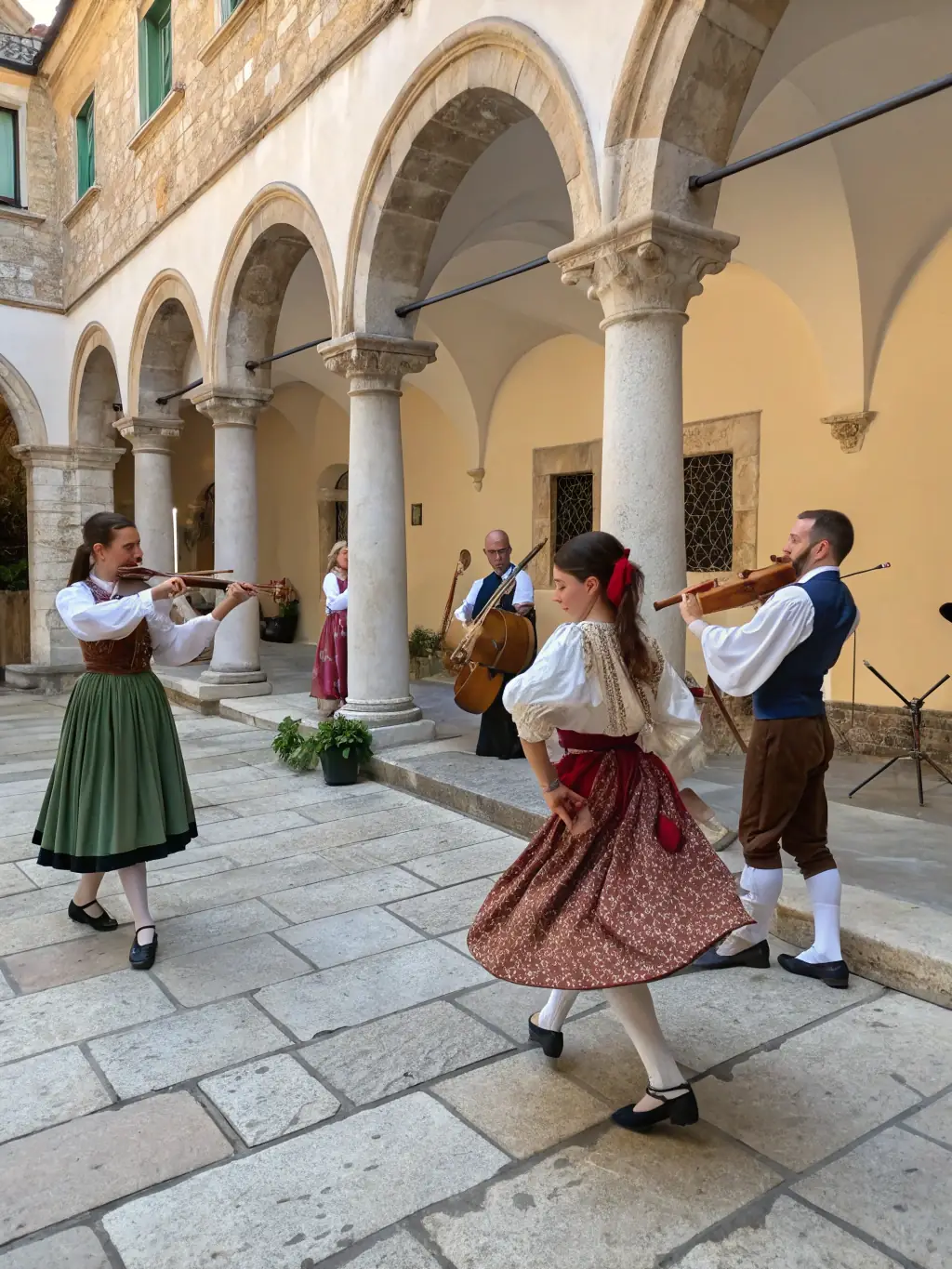 A photograph of a traditional music performance taking place inside the Sainte-Brigitte Chapel, showcasing local musicians playing historical instruments and singing traditional songs.
